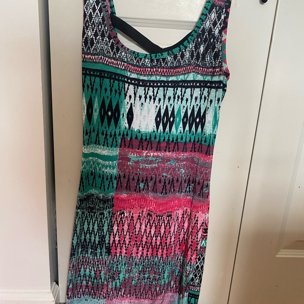 Pink, teal and black patterned mini dress. Stretchy material with open fun back.